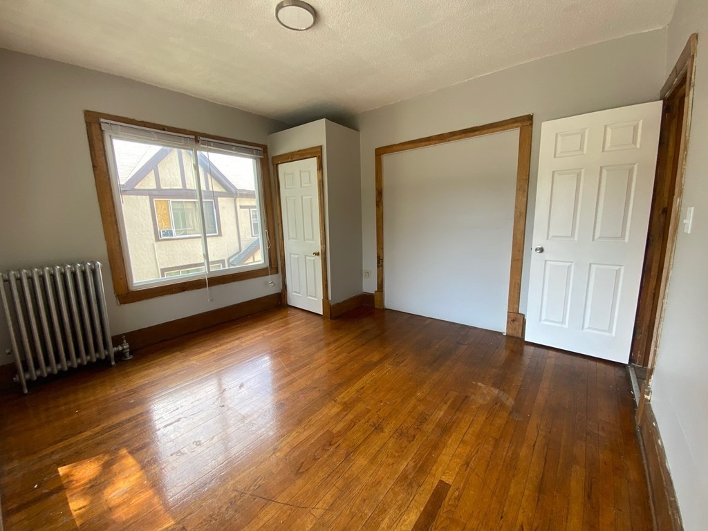 331-335 Allen Street Springfield, MA 01108 - Photo 7 of 8 an empty room with wooden floor and windows