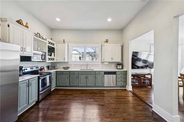 a kitchen with granite countertop a stove top oven sink and cabinets
