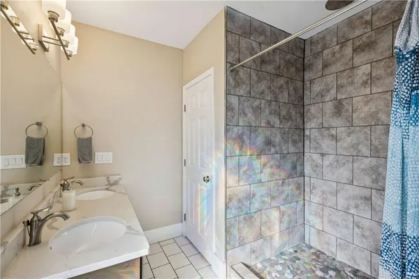 a bathroom with a sink and shower