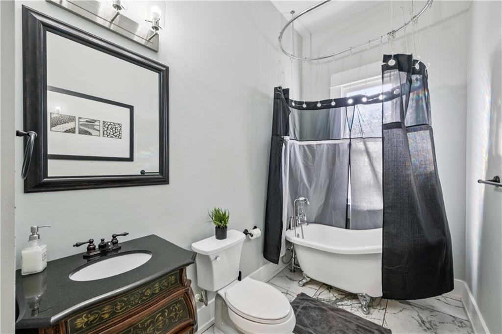 528 Holderness Street Southwest Atlanta, GA 30310 - Photo 19 of 42 a bathroom with a granite countertop sink mirror vanity and toilet