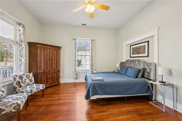 a bedroom with a large bed and a chandelier