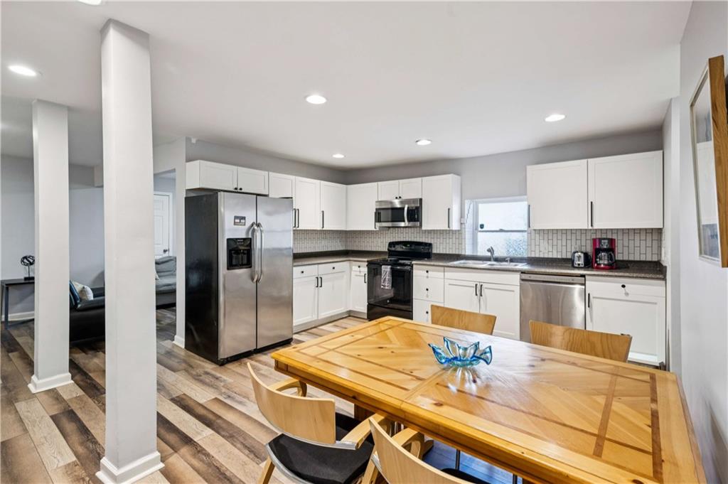 528 Holderness Street Southwest Atlanta, GA 30310 - Photo 28 of 42 a kitchen with stainless steel appliances kitchen island granite countertop a refrigerator and a stove top oven