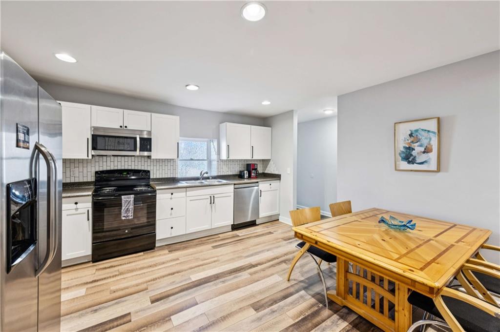 528 Holderness Street Southwest Atlanta, GA 30310 - Photo 29 of 42 a kitchen with a stove a sink and a refrigerator