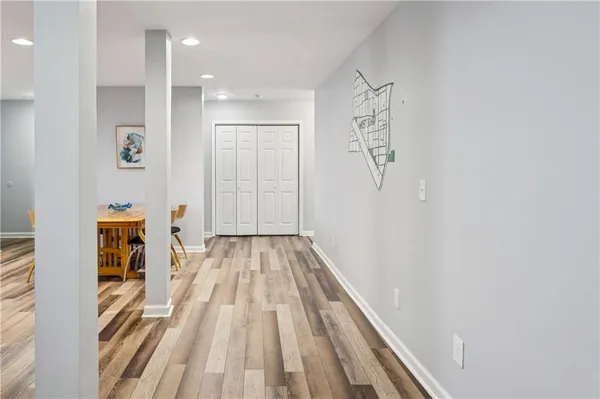 a view of a bedroom with wooden floor and bathroom