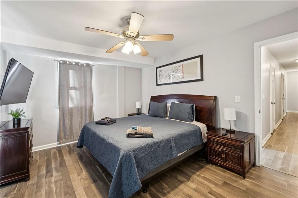 528 Holderness Street Southwest Atlanta, GA 30310 - Photo 37 of 42 a bedroom with a bed and a chandelier