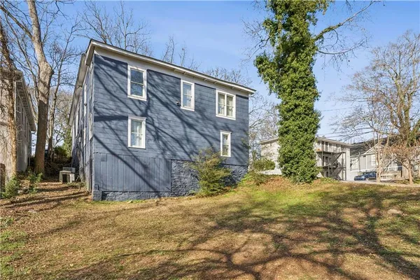 a view of a house with a yard