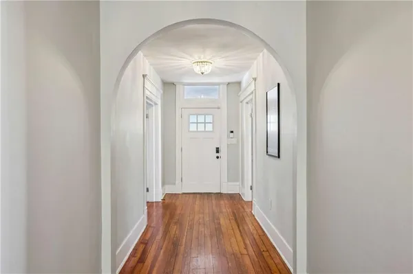a view of a hallway with wooden floor