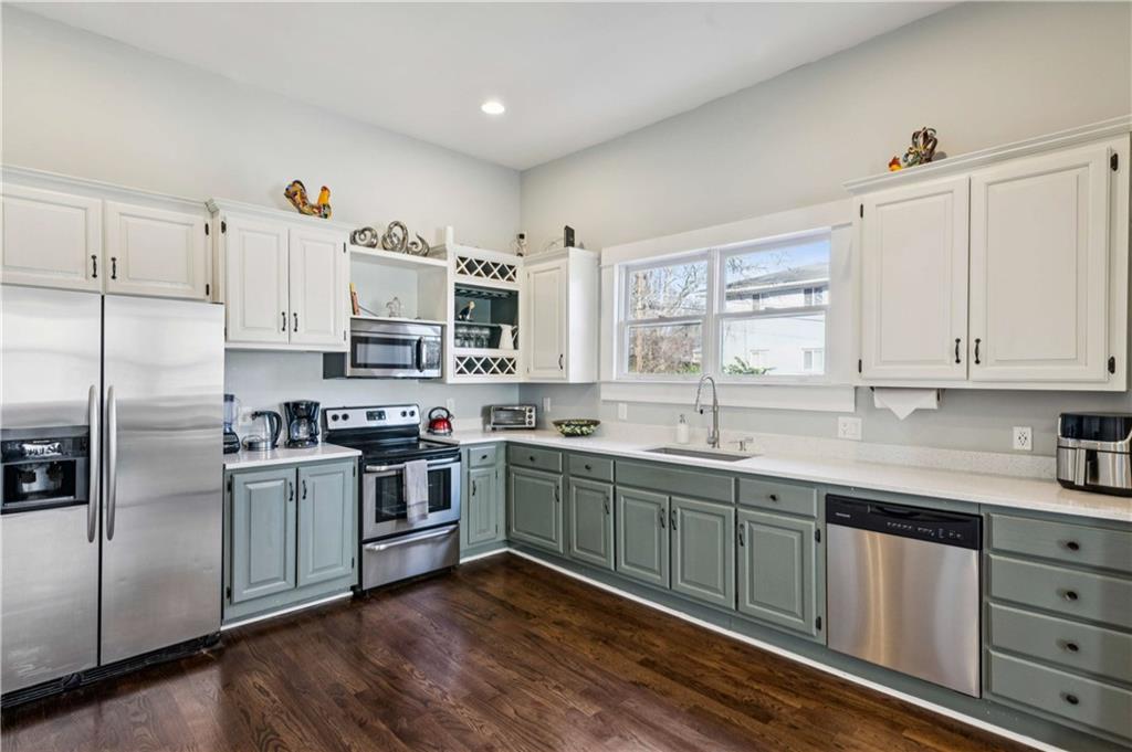 528 Holderness Street Southwest Atlanta, GA 30310 - Photo 10 of 42 a kitchen with stainless steel appliances granite countertop a stove a sink dishwasher and a refrigerator