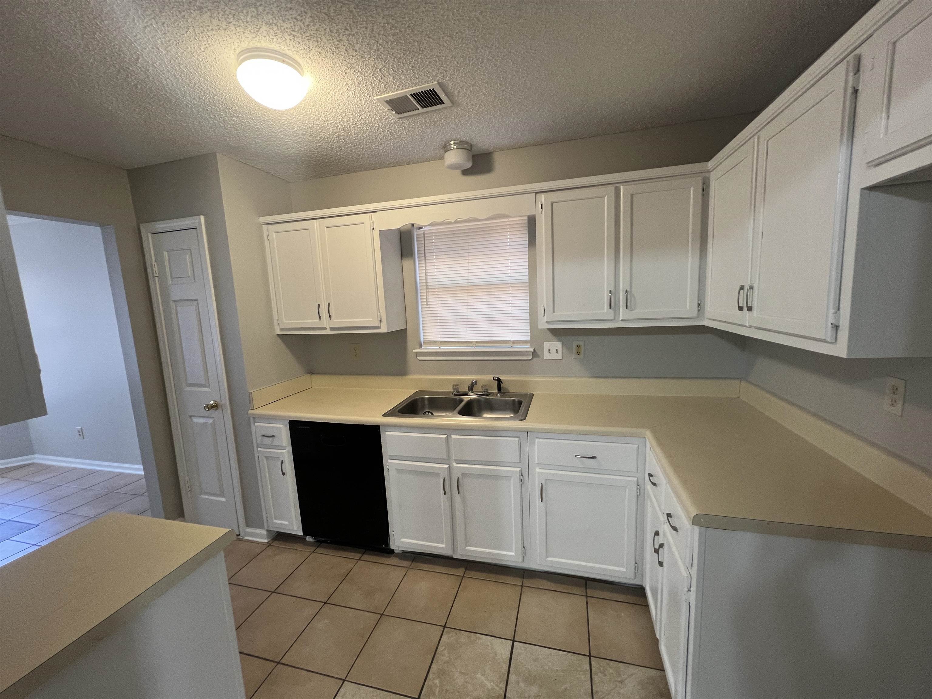 3315 Tulane Road West Horn Lake, MS 38637 - Photo 12 of 13 a kitchen with a sink a stove and cabinets