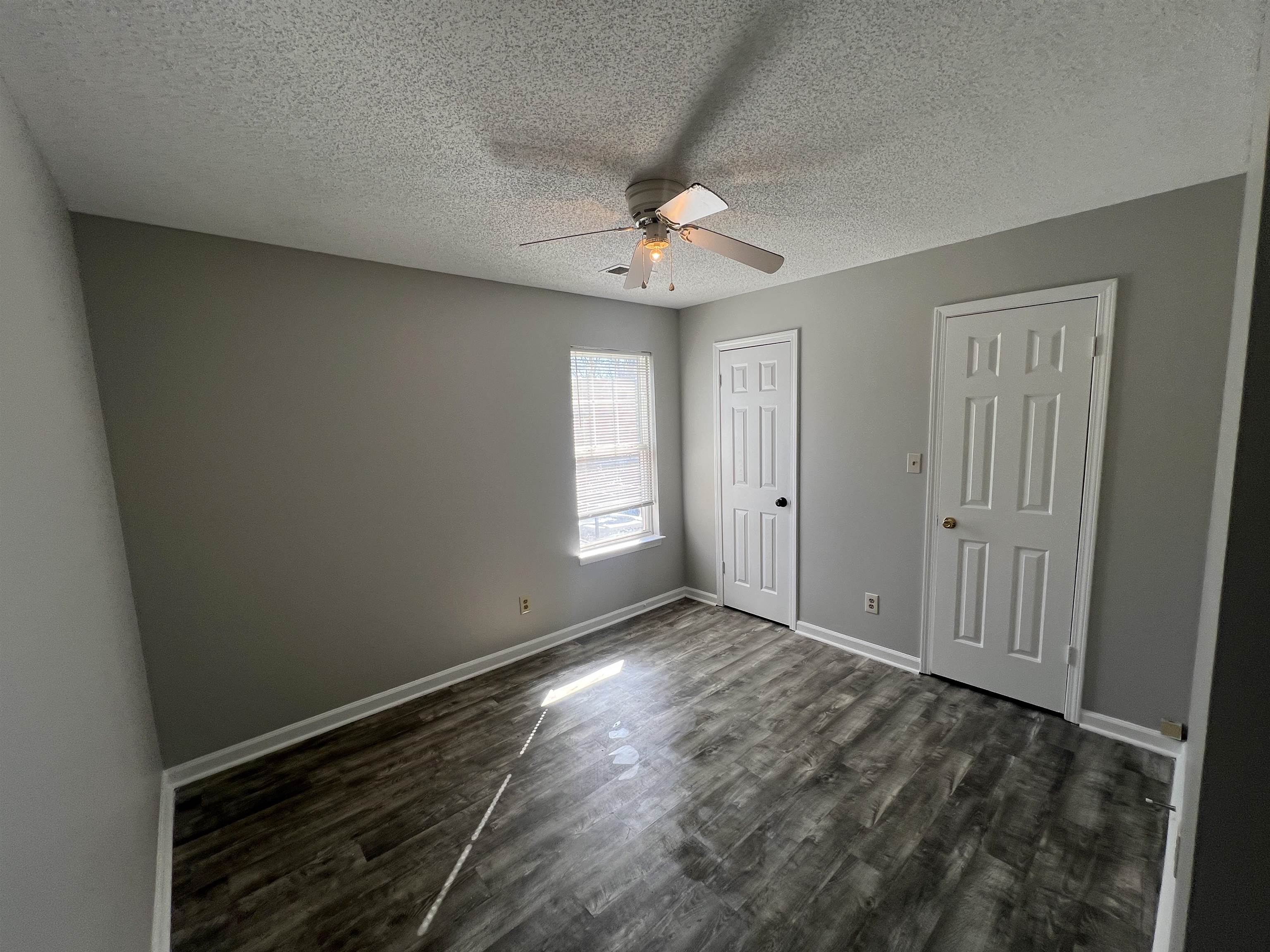 3315 Tulane Road West Horn Lake, MS 38637 - Photo 7 of 13 wooden floor in an empty room with a window