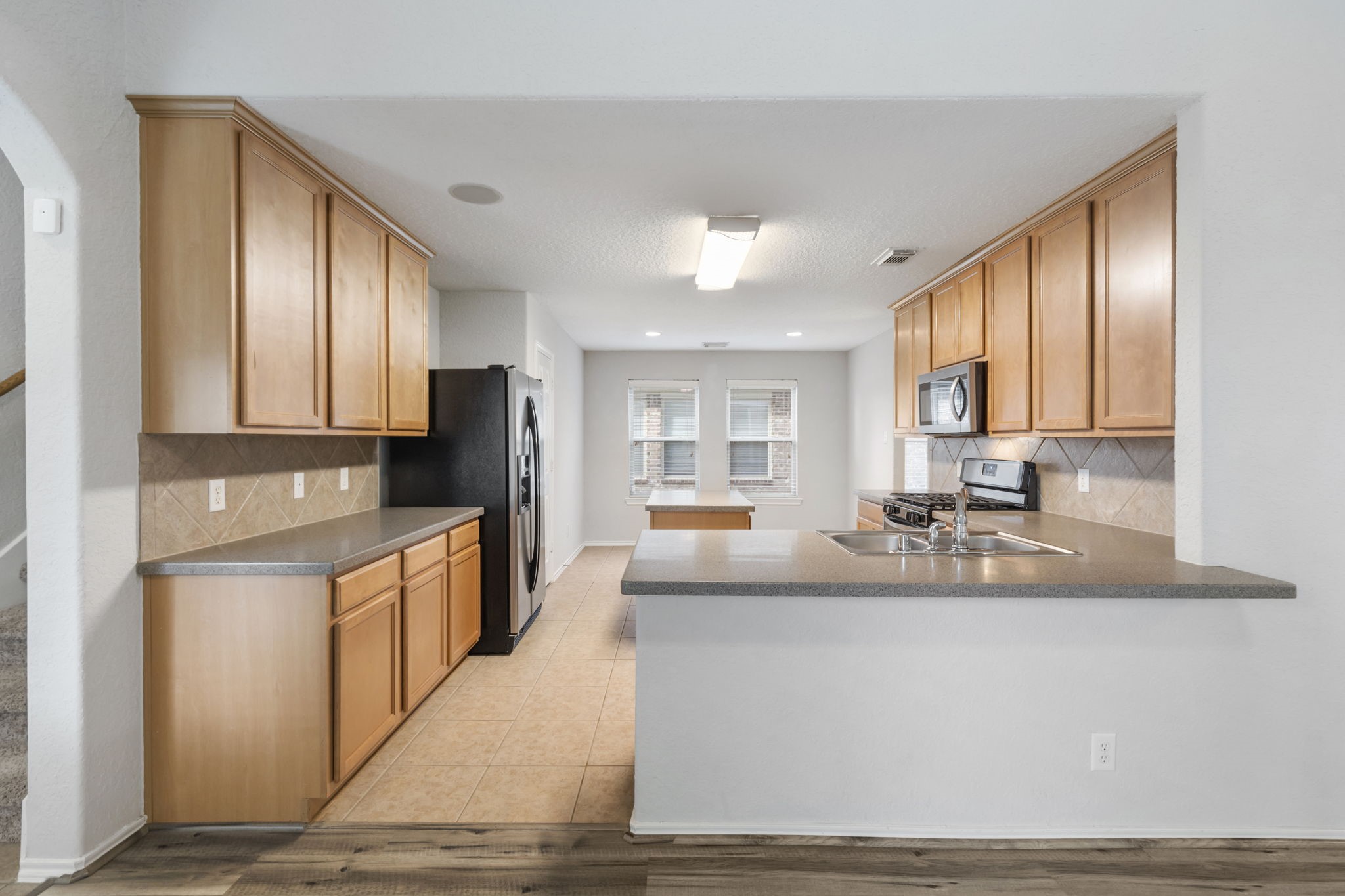 21810 Colter Stone Drive Spring, TX 77388 - Photo 12 of 33 a large kitchen with granite countertop a large window and stainless steel appliances