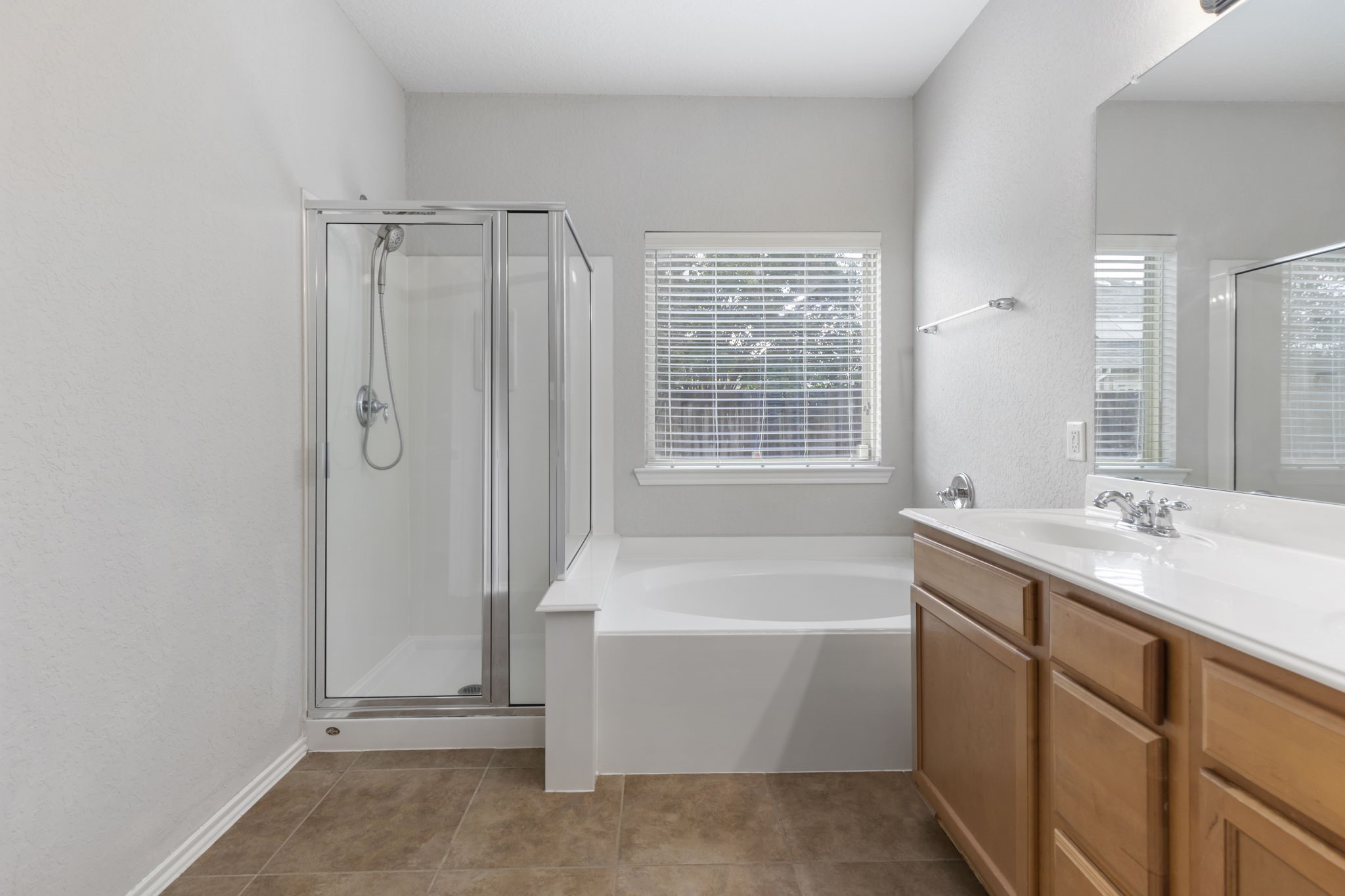 21810 Colter Stone Drive Spring, TX 77388 - Photo 17 of 33 a bathroom with a tub sink and mirror