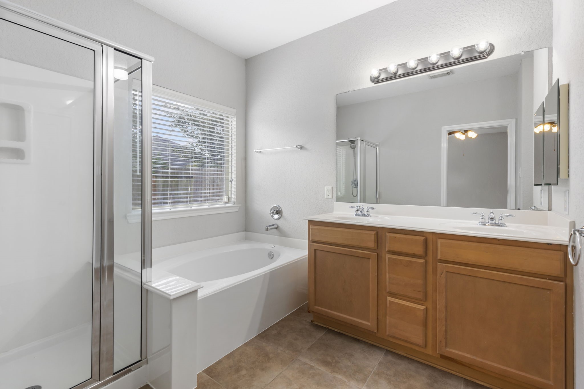 21810 Colter Stone Drive Spring, TX 77388 - Photo 18 of 33 a spacious bathroom with a tub sink shower and mirror