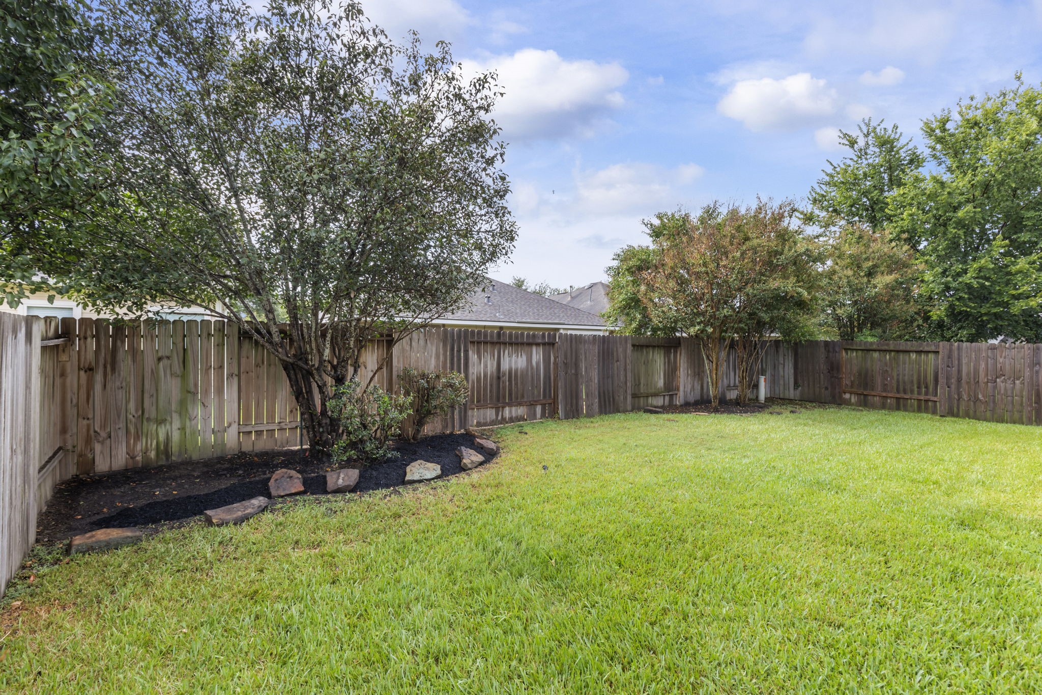 21810 Colter Stone Drive Spring, TX 77388 - Photo 31 of 33 a view of a backyard with wooden fence and a large tree