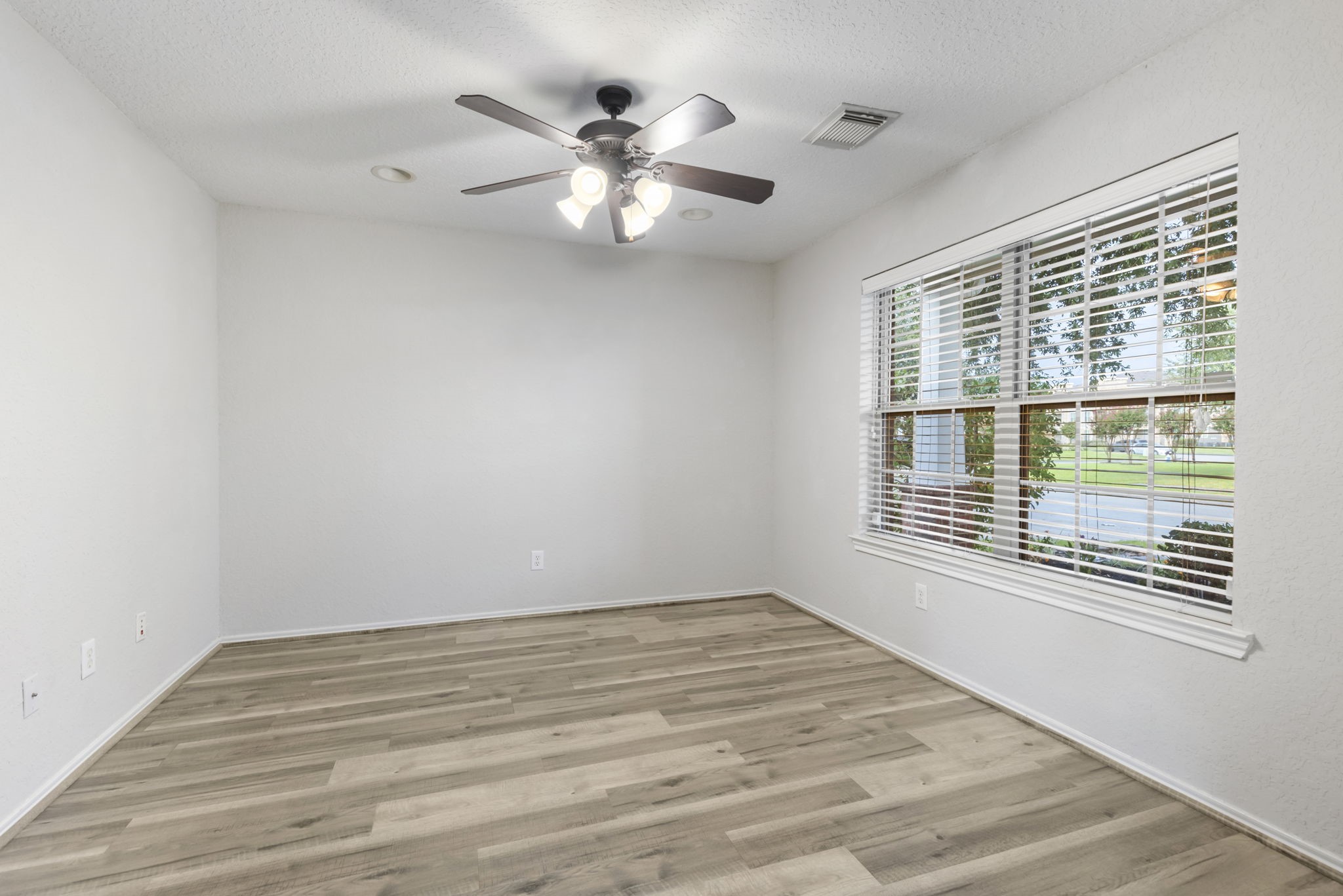 21810 Colter Stone Drive Spring, TX 77388 - Photo 8 of 33 a view of an empty room with a window and wooden floor