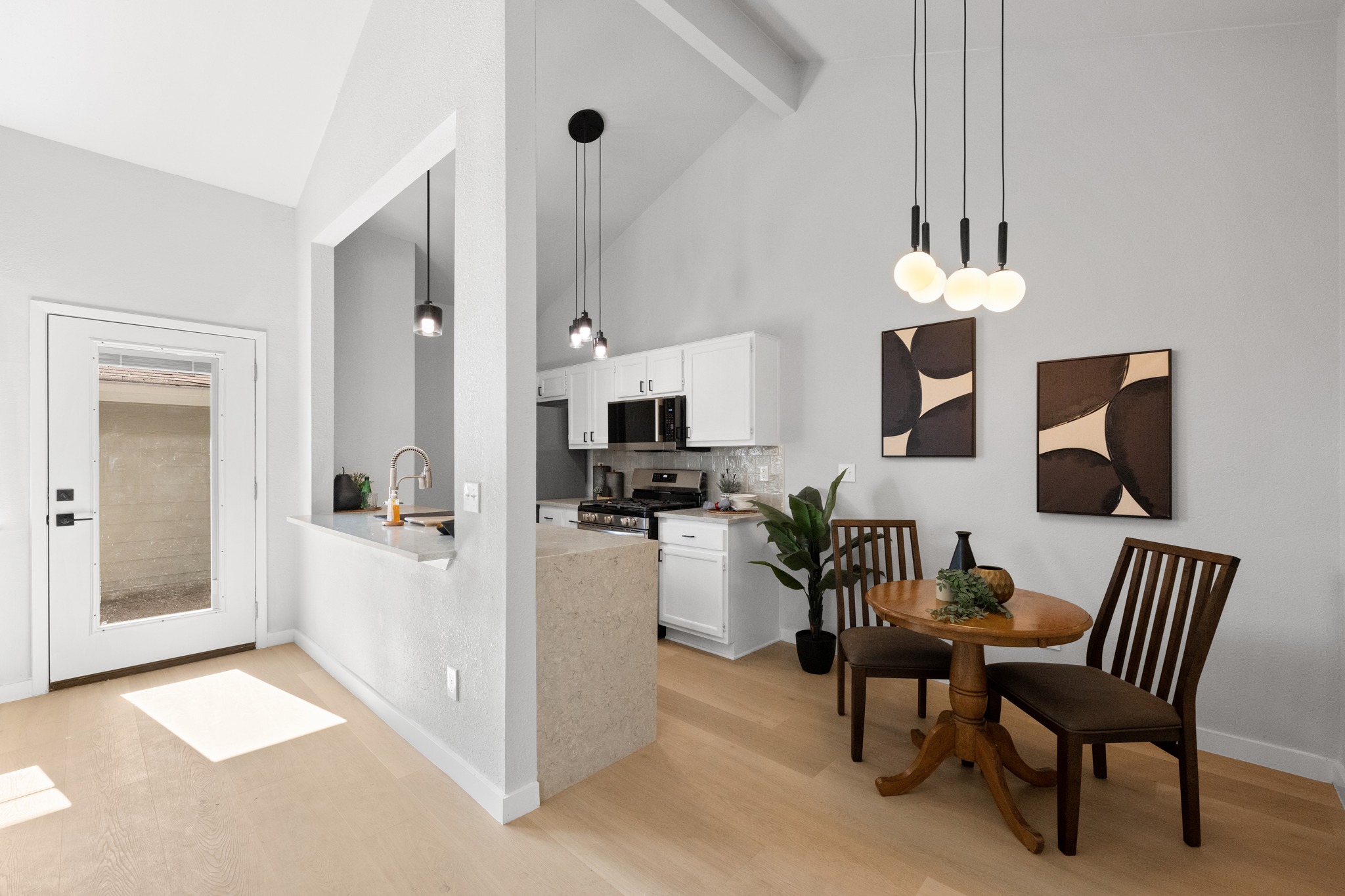 6501 Brush Country Road, Unit 120 Austin, TX 78749 - Photo 6 of 26 Vaulted ceilings enhance the open-concept design, featuring three beautiful pendants