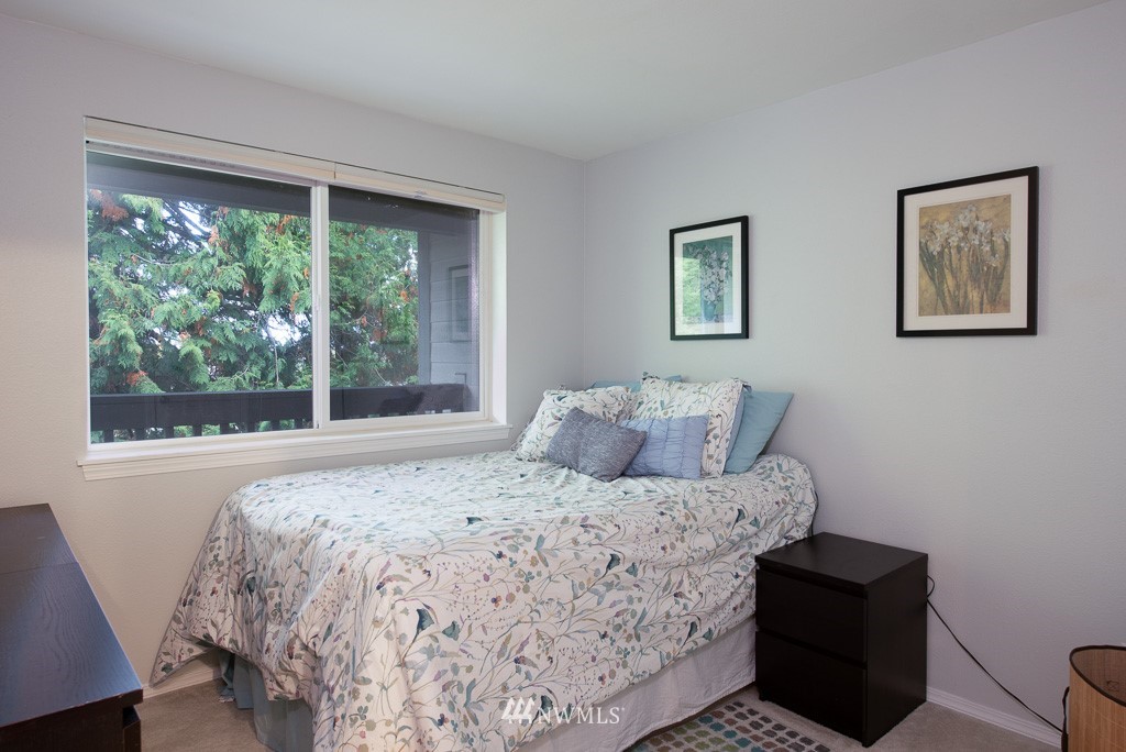 2152 North 112th Street, Unit 303 Seattle, WA 98133 - Photo 13 of 19 a bedroom with a bed and a large window