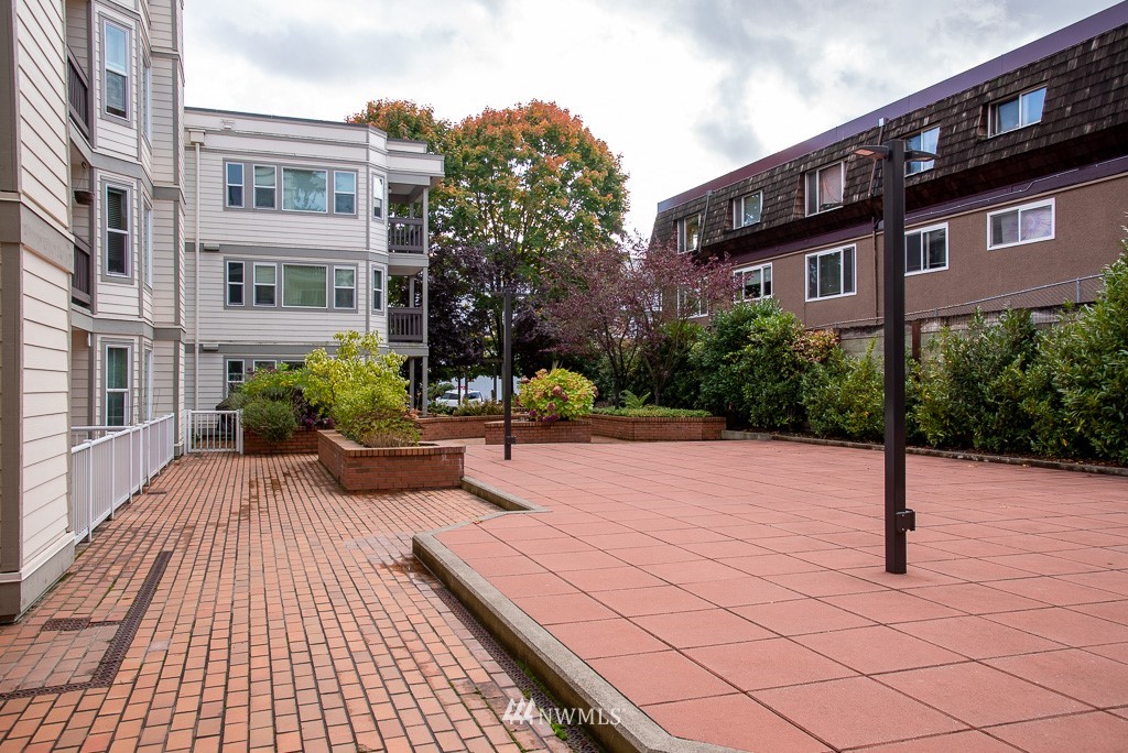 2152 North 112th Street, Unit 303 Seattle, WA 98133 - Photo 18 of 19 a view of a brick building next to a road