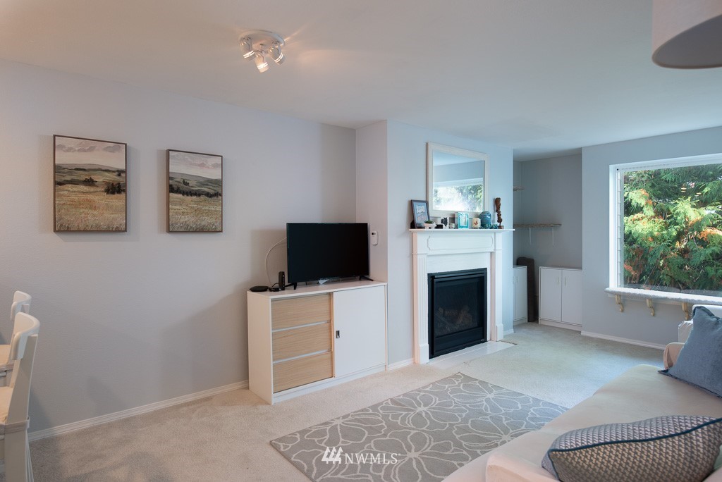 2152 North 112th Street, Unit 303 Seattle, WA 98133 - Photo 3 of 19 a living room with furniture and a flat screen tv