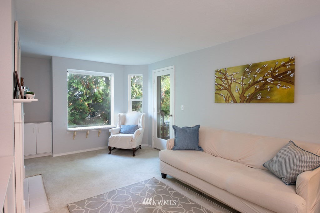 2152 North 112th Street, Unit 303 Seattle, WA 98133 - Photo 5 of 19 a living room with furniture and a large window
