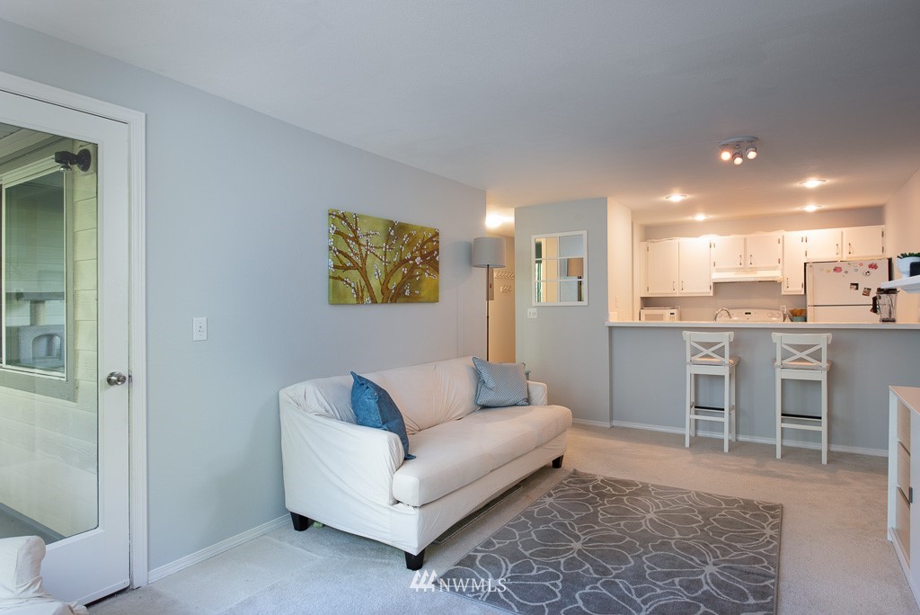 2152 North 112th Street, Unit 303 Seattle, WA 98133 - Photo 6 of 19 a living room with furniture and kitchen view