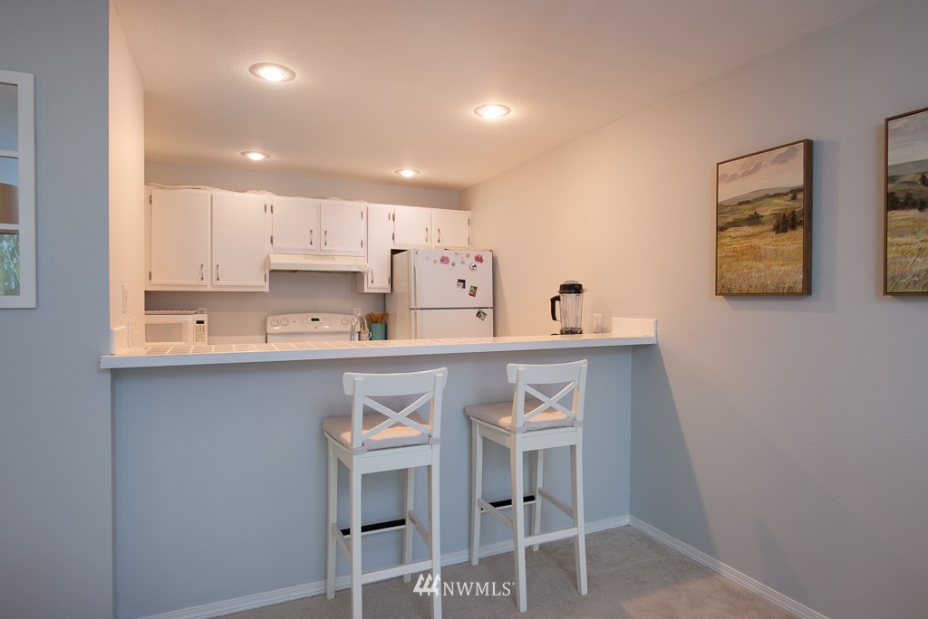 2152 North 112th Street, Unit 303 Seattle, WA 98133 - Photo 8 of 19 a kitchen with a sink cabinets and window