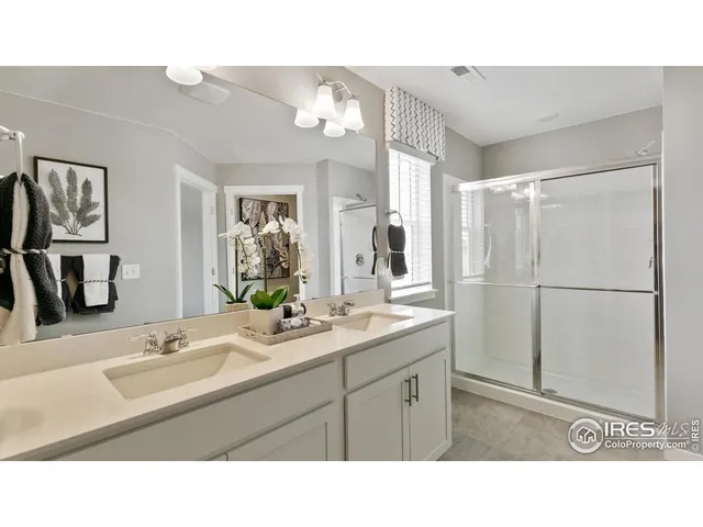 a bathroom with a sink a large mirror and vanity