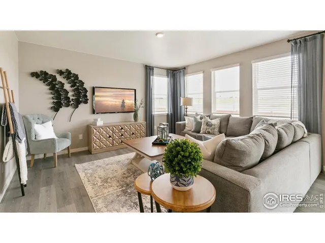 a living room with furniture potted plant and a window