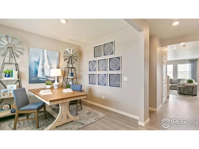 a living room with furniture and a dining table