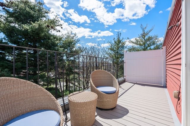 a outdoor sitting area with furniture and wooden floor