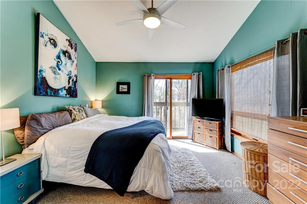 25030 Riley Lane Tega Cay, SC 29708 - Photo 15 of 48 a bedroom with a bed dresser and a flat tv screen
