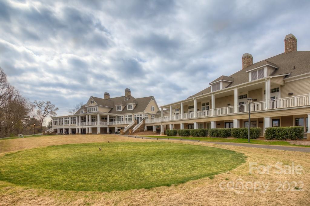 25030 Riley Lane Tega Cay, SC 29708 - Photo 34 of 48 a front view of a building with a garden and trees