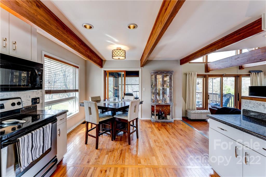 25030 Riley Lane Tega Cay, SC 29708 - Photo 10 of 48 a view of a dining room with furniture window and wooden floor