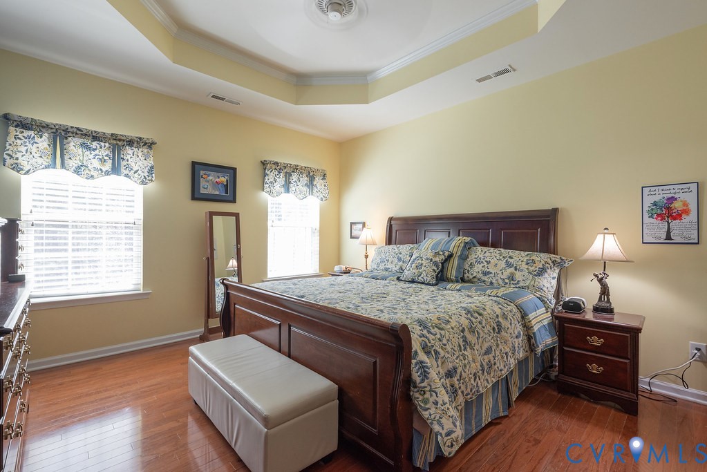 10523 Tea Olive Circle Providence Forge, VA 23140 - Photo 21 of 46 a bedroom with a bed and wooden floor