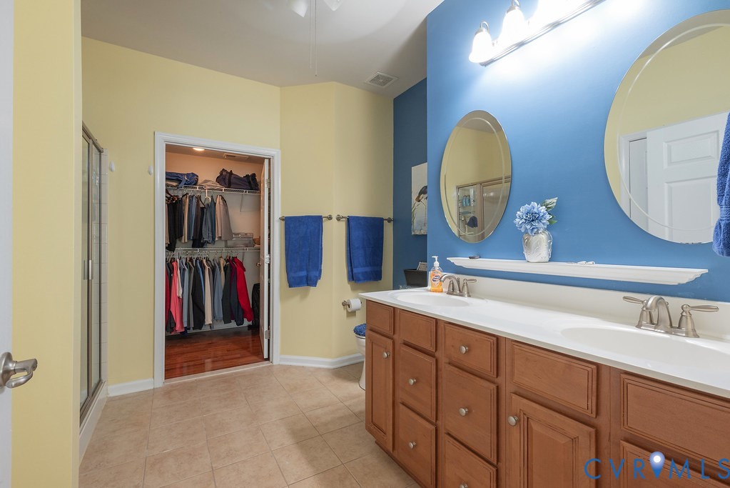 10523 Tea Olive Circle Providence Forge, VA 23140 - Photo 24 of 46 a bathroom with a double vanity sink and a mirror