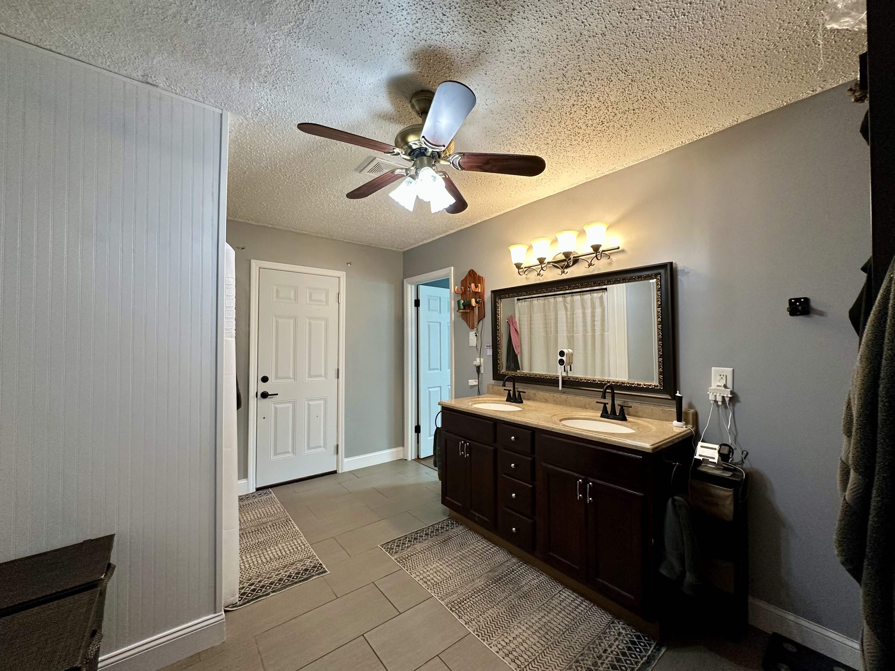 1230 Joann Road Somerville, TN 38068 - Photo 16 of 29 Full bath with double vanity, ceiling fan, a textured ceiling, and light tile patterned flooring