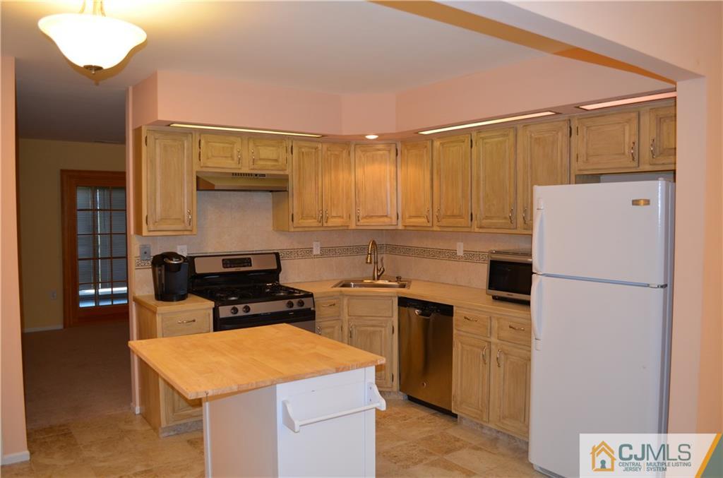225 Constitution Circle North Brunswick, NJ 08902 - Photo 2 of 17 a kitchen with a refrigerator a stove a sink and a microwave