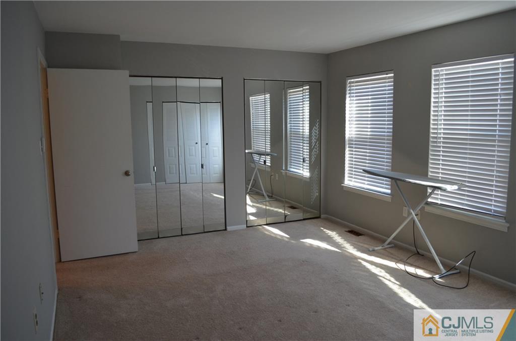 225 Constitution Circle North Brunswick, NJ 08902 - Photo 13 of 17 a view of a room with gym equipment and windows