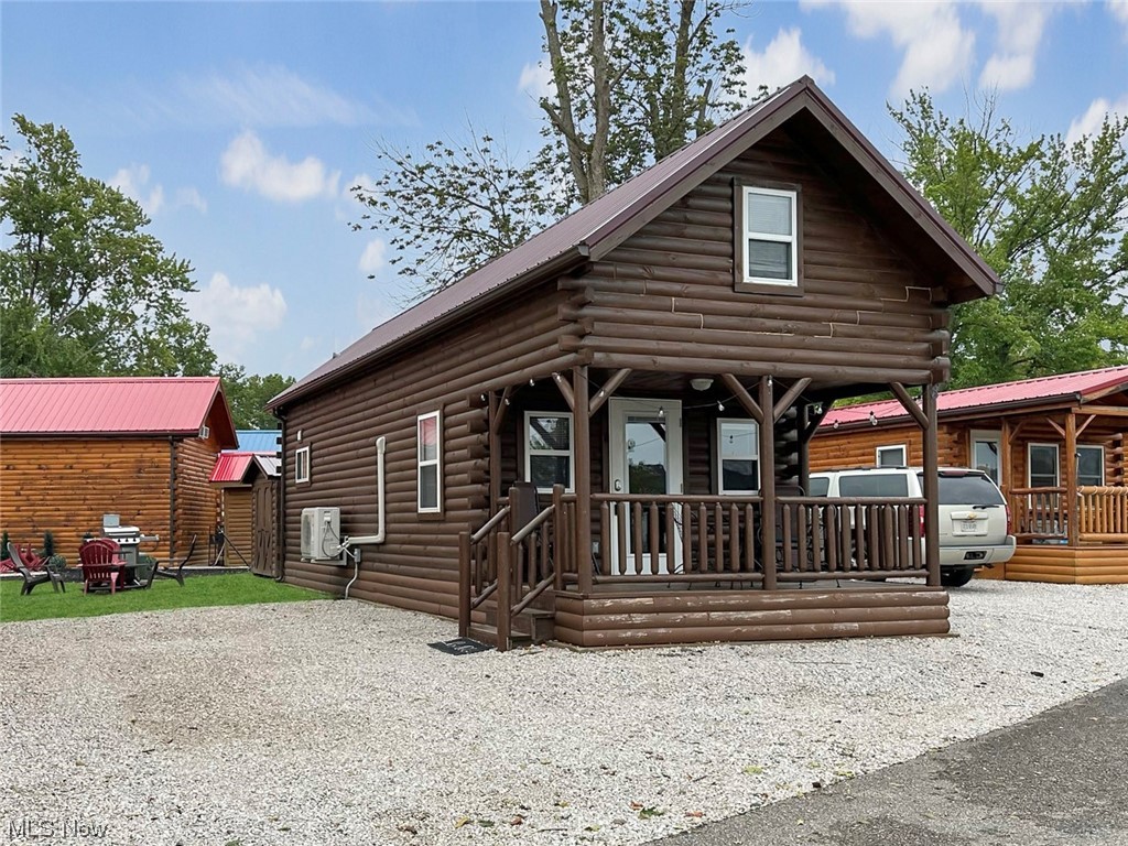 5919 Lake Road West, Unit 8 Ashtabula, OH 44004 - Photo 1 of 35 Log cabin with covered front porch