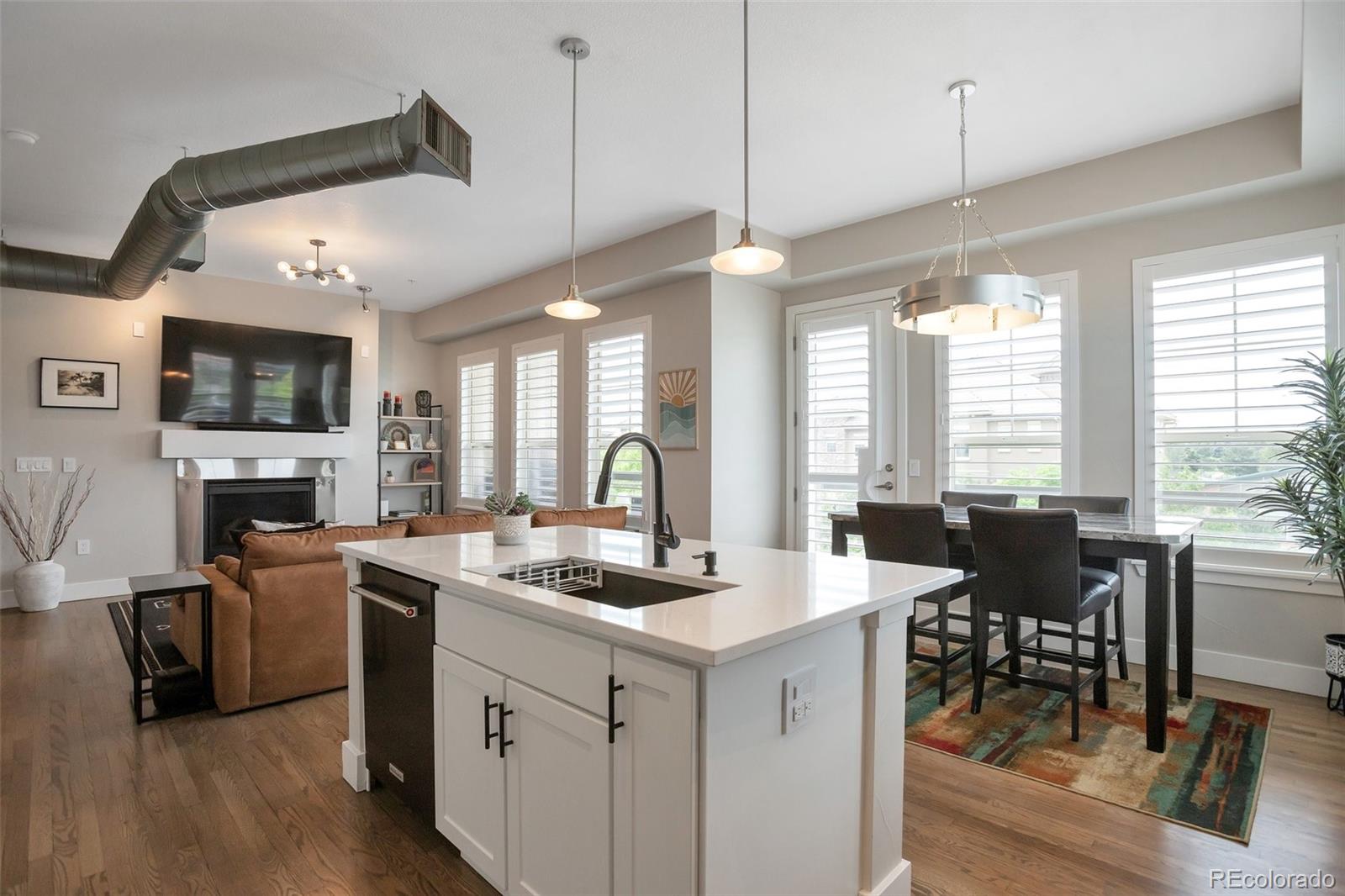 a kitchen that has a lot of cabinets in it and a wooden floor