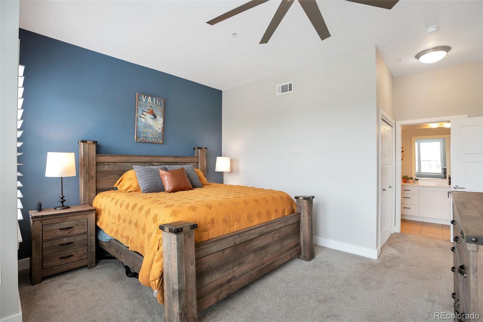 10111 Inverness Main Street, Unit 301 Englewood, CO 80112 - Photo 11 of 28 a bed room with a bed and a lamp