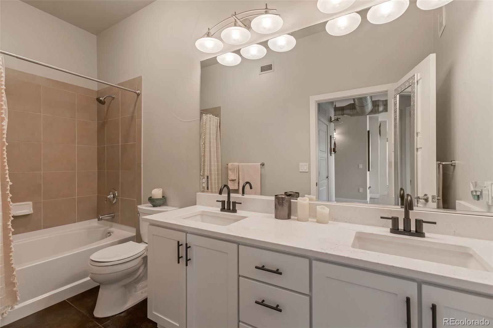 10111 Inverness Main Street, Unit 301 Englewood, CO 80112 - Photo 14 of 28 a bathroom with a double vanity sink and a mirror
