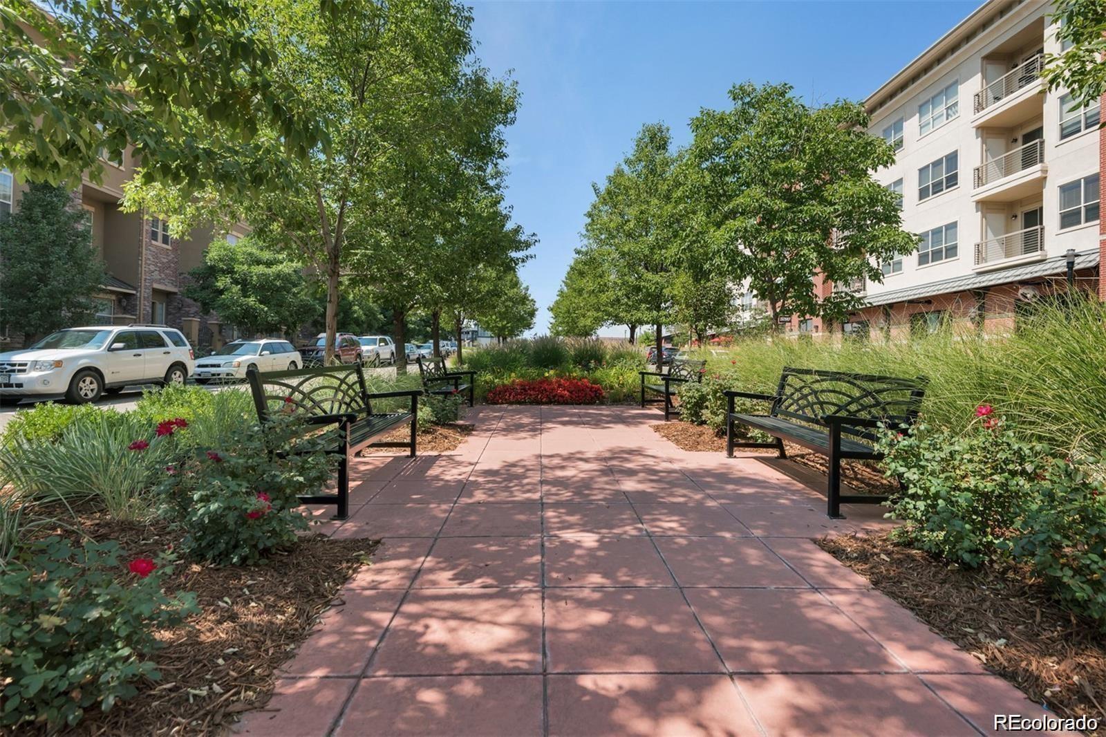 10111 Inverness Main Street, Unit 301 Englewood, CO 80112 - Photo 23 of 28 a view of a street with a bench and trees