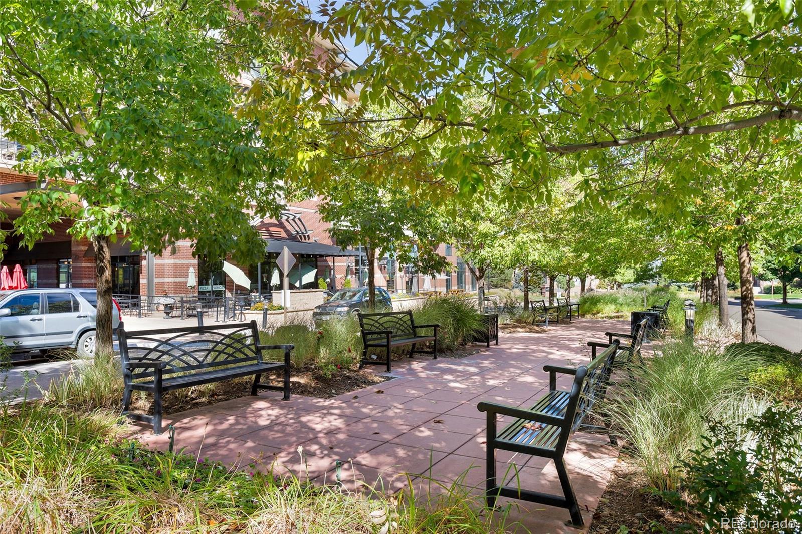 10111 Inverness Main Street, Unit 301 Englewood, CO 80112 - Photo 27 of 28 a view of a bench in a garden