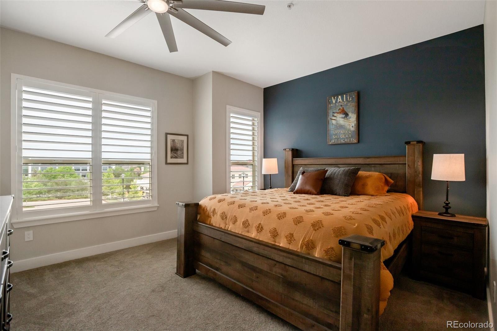 10111 Inverness Main Street, Unit 301 Englewood, CO 80112 - Photo 10 of 28 a bed sitting in a bedroom next to a window