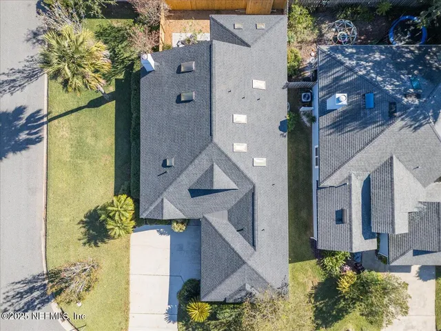 a picture of a house with a yard and potted plants