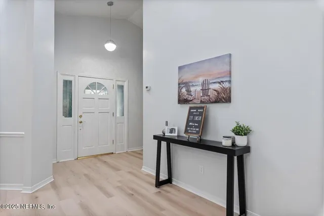 a kitchen with stainless steel appliances kitchen island granite countertop a dining table and chairs