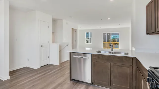 a kitchen with a sink cabinets and wooden floor