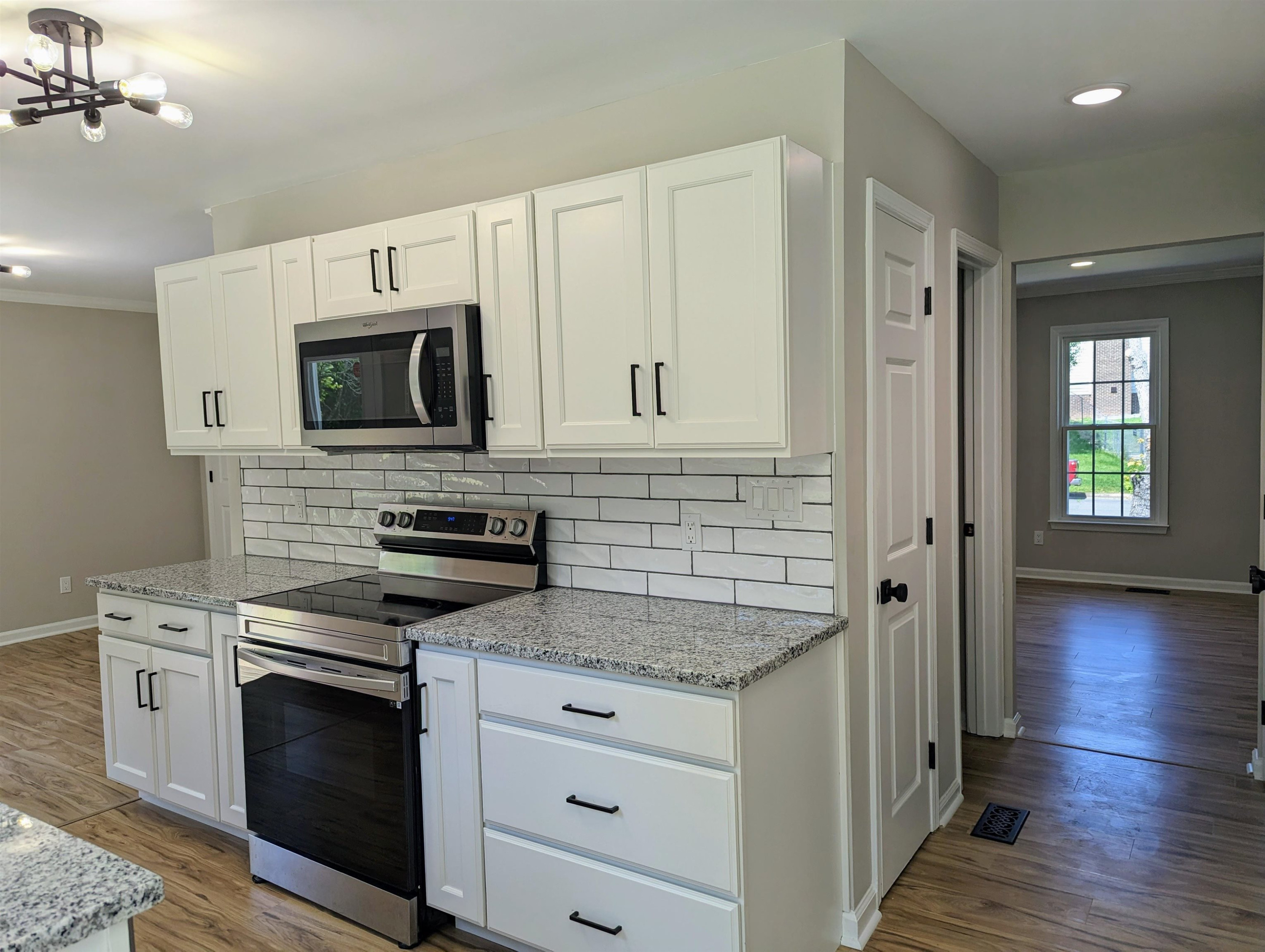 2 Austin Court Durham, NC 27707 - Photo 11 of 29 a kitchen with stainless steel appliances white cabinets and stove top oven