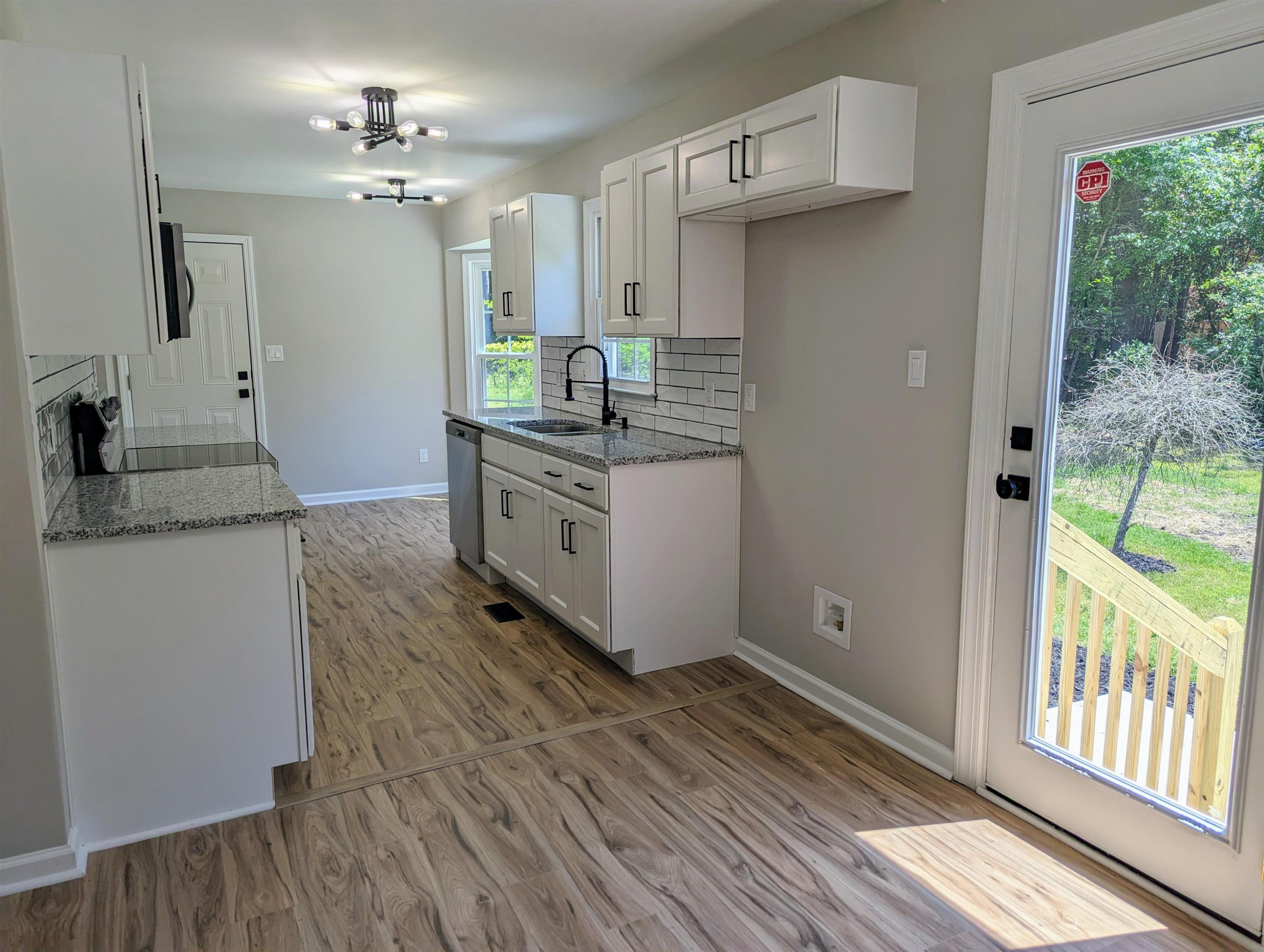2 Austin Court Durham, NC 27707 - Photo 12 of 29 a kitchen with stainless steel appliances granite countertop a sink and a stove next to a window